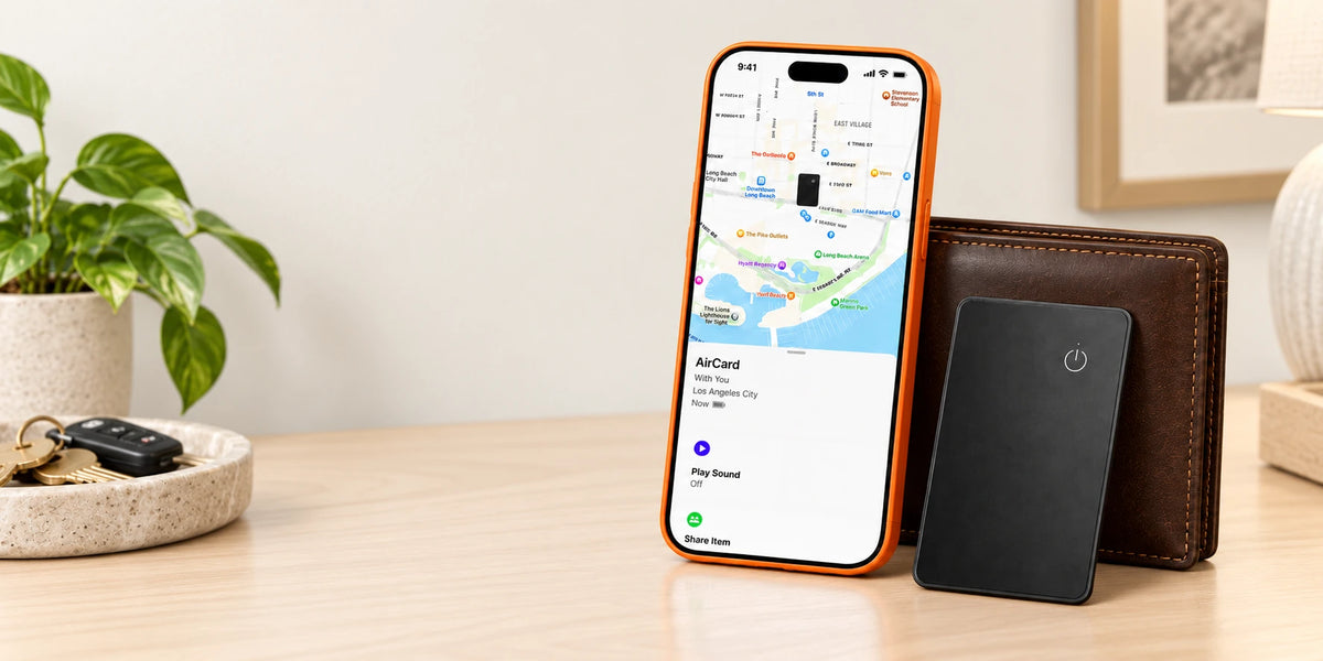 Black tracker card beside a wallet and a phone showing the supplied tracking screen.