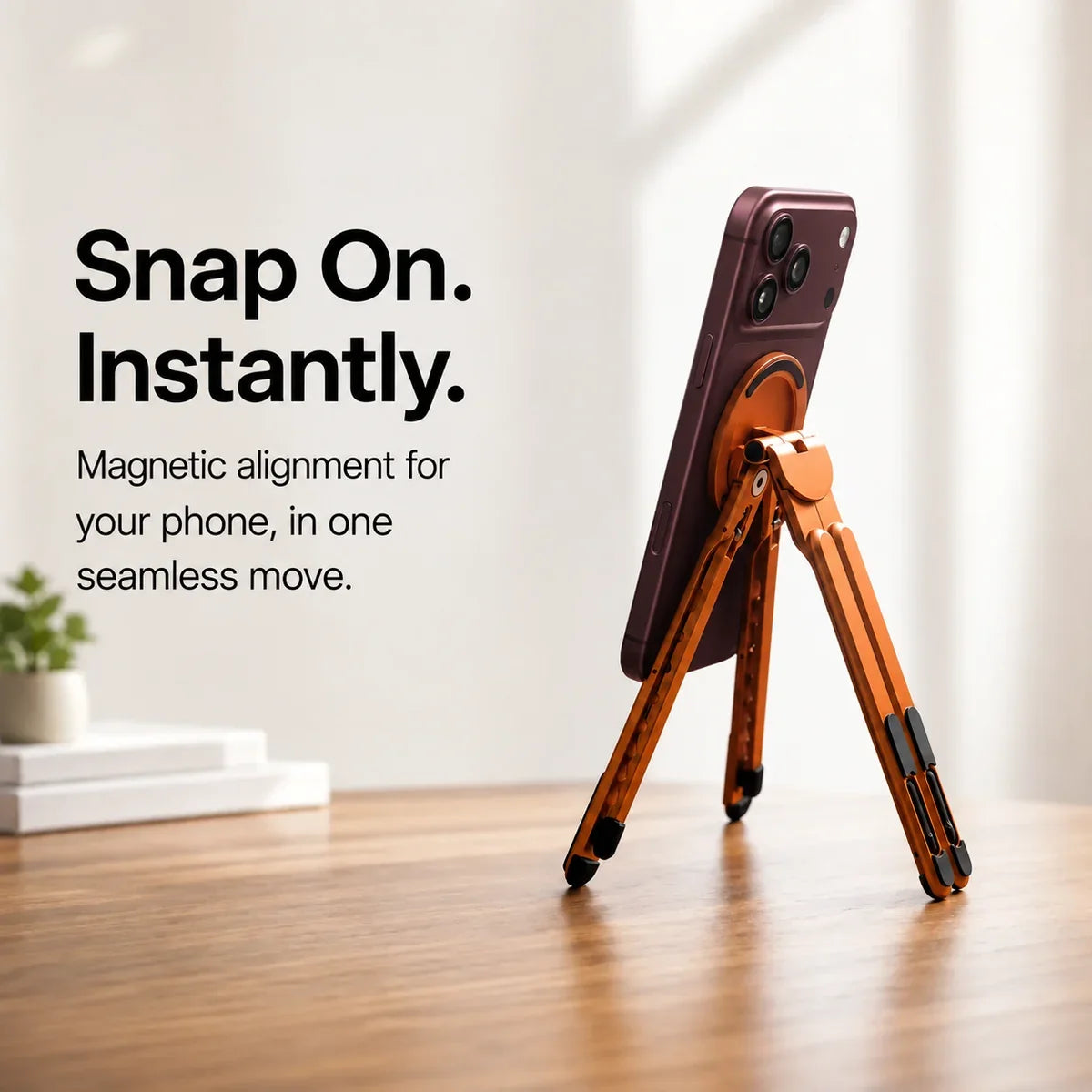 Cosmic Orange magnetic tripod stand supporting a Burgundy iPhone from behind. #color_Cosmic Orange
