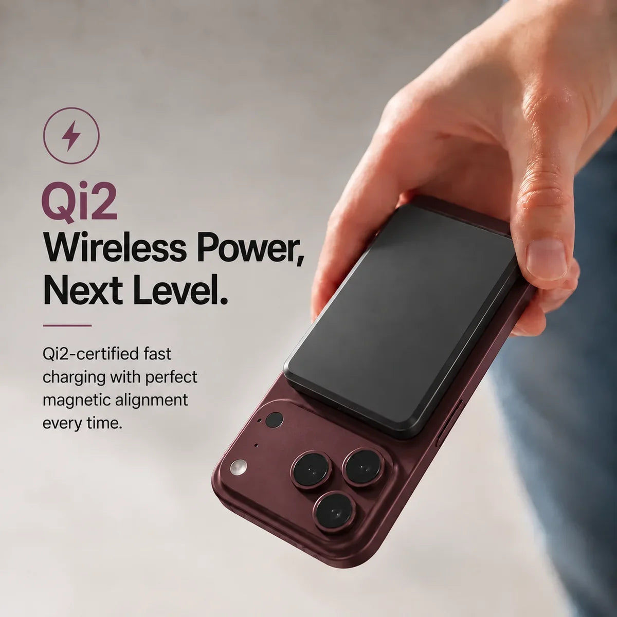Midnight Black slim magnetic power bank attaching magnetically to a Burgundy phone. #color_Midnight Black