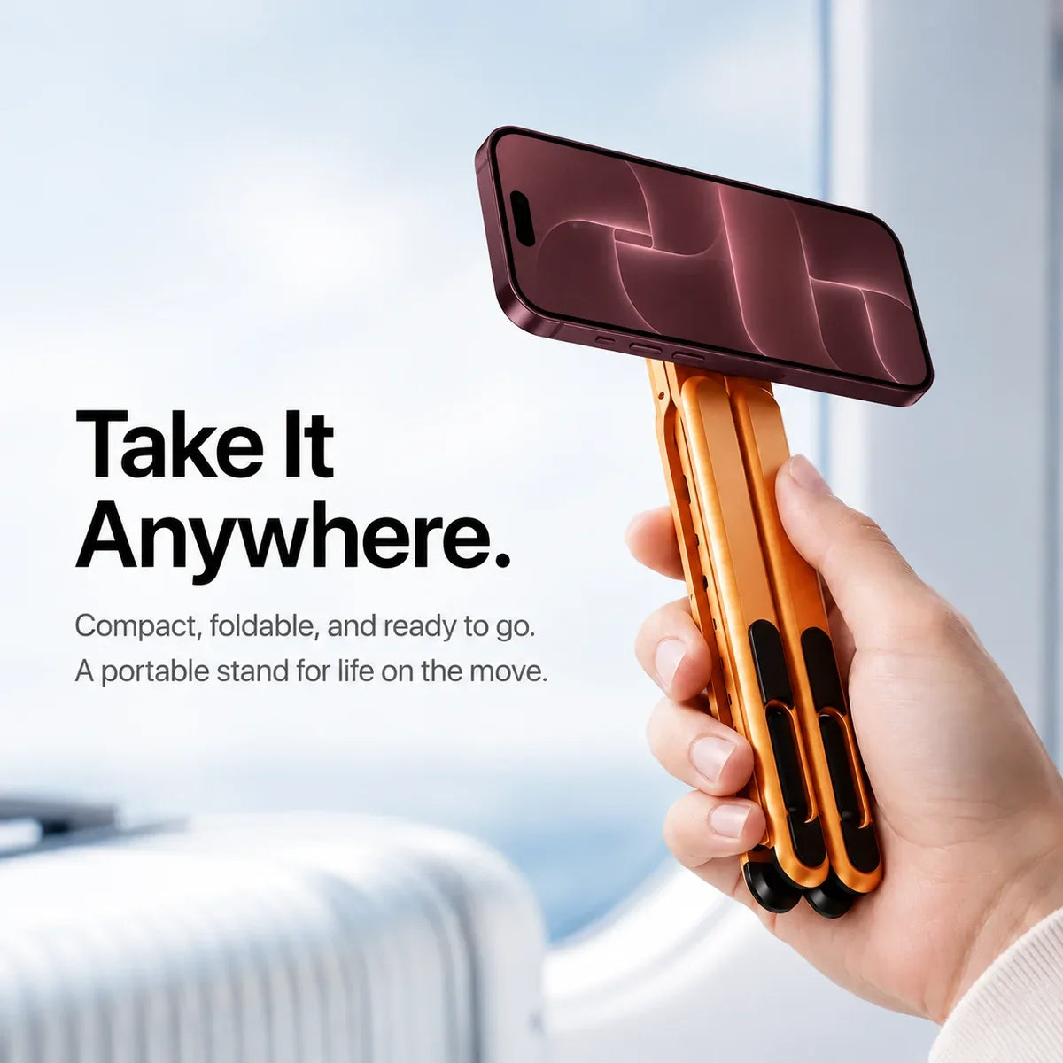 Hand holding a folded Cosmic Orange magnetic stand with a Burgundy iPhone in landscape orientation. #color_Cosmic Orange