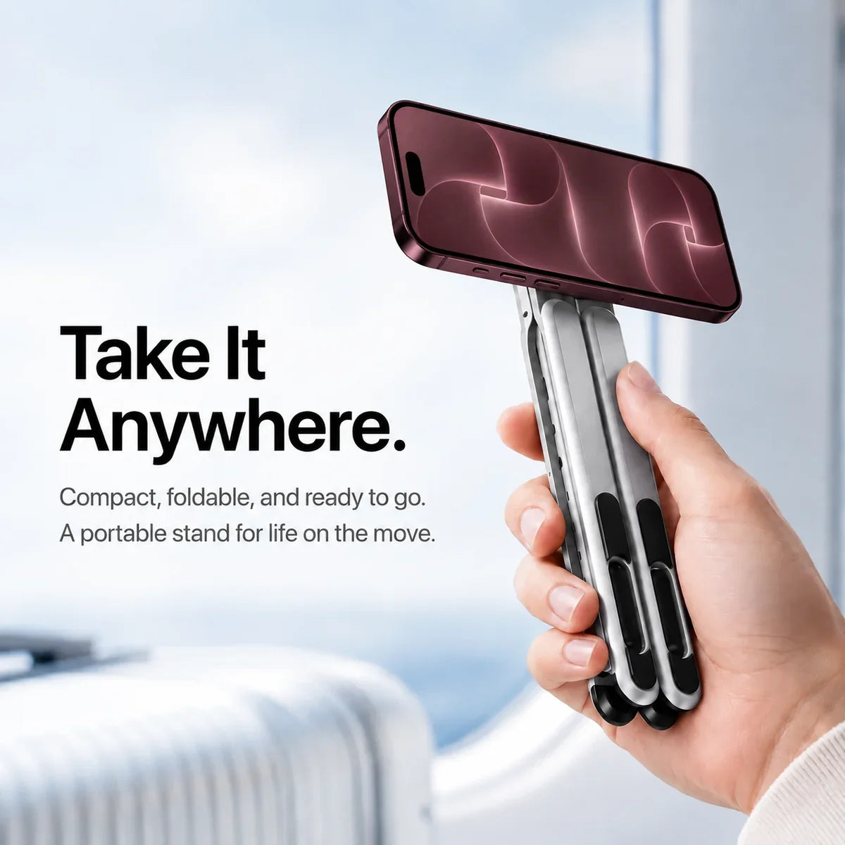 Hand holding a folded Titanium Silver magnetic stand with a Burgundy iPhone in landscape orientation. #color_Titanium Silver