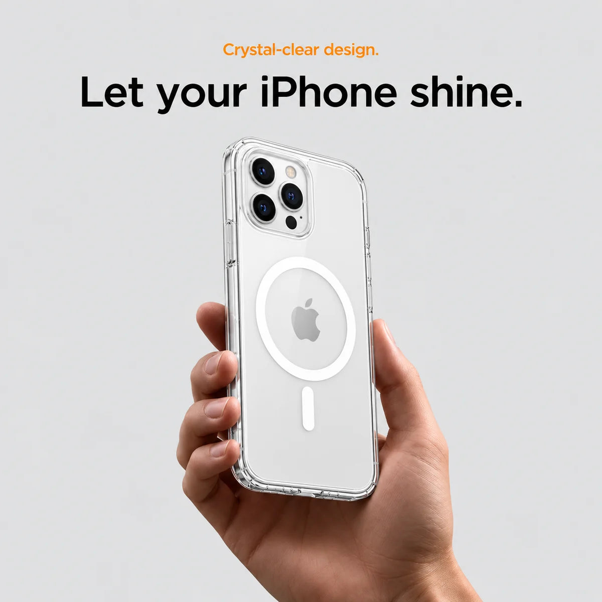 Clear magnetic phone case held at an angle, showing its transparent back and camera openings. #iPhone Model_iPhone 12 Pro