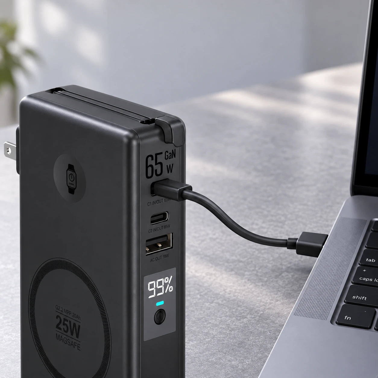 USB-C cable connecting a black power bank to a laptop.