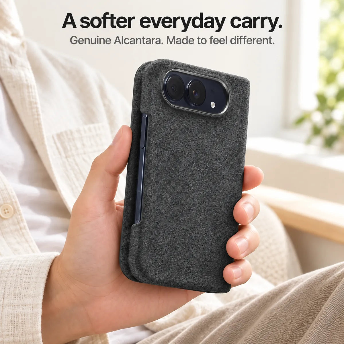 Charcoal Gray Alcantara folio case for iPhone Duo, held in a hand to show the soft fabric finish #color_Charcoal Gray