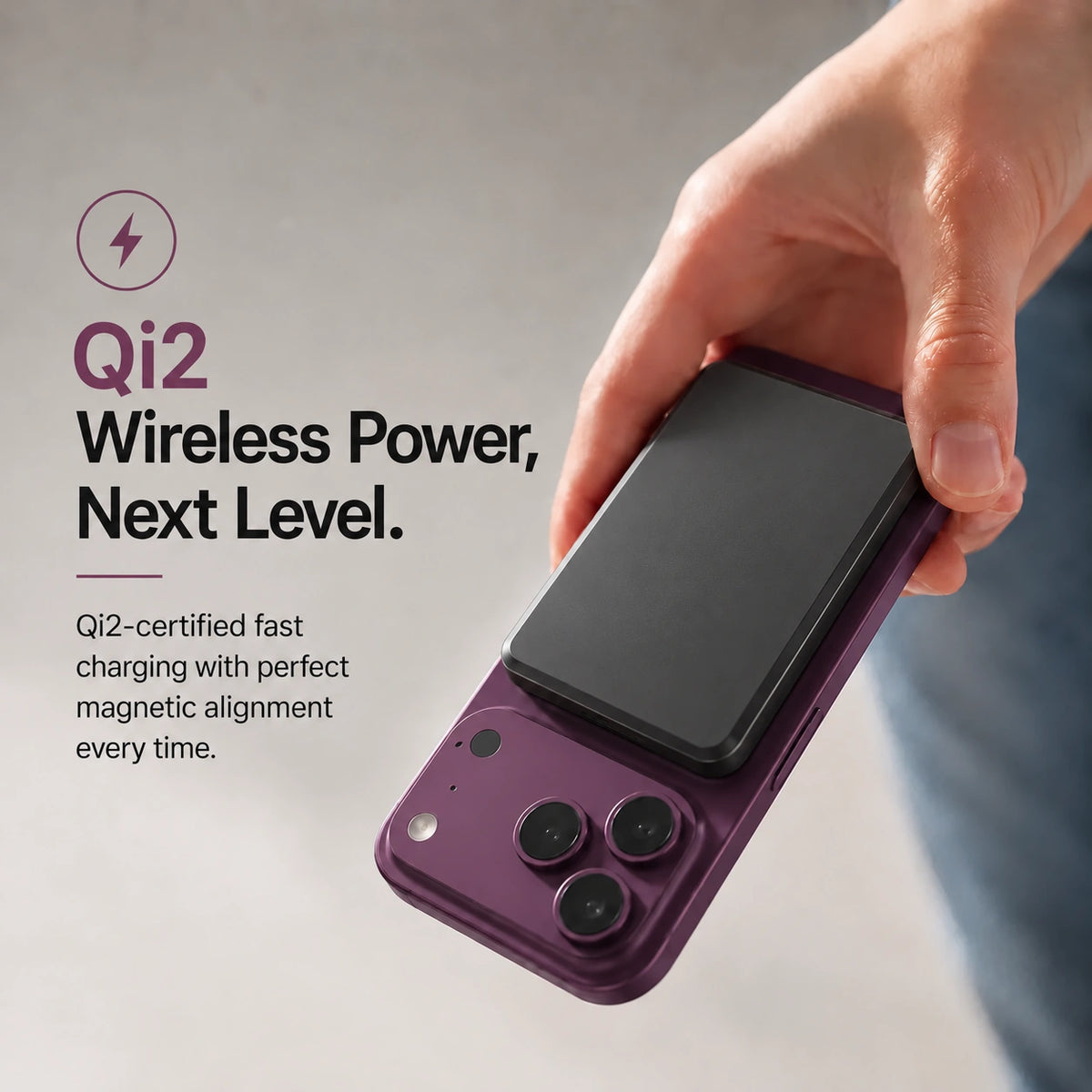 Midnight Black slim magnetic power bank attaching magnetically to a Burgundy phone. #color_Midnight Black