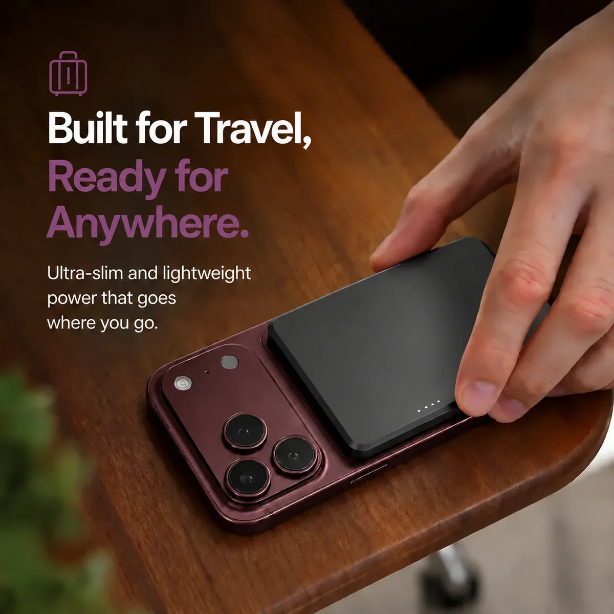 Midnight Black slim magnetic power bank being packed for travel. #color_Midnight Black