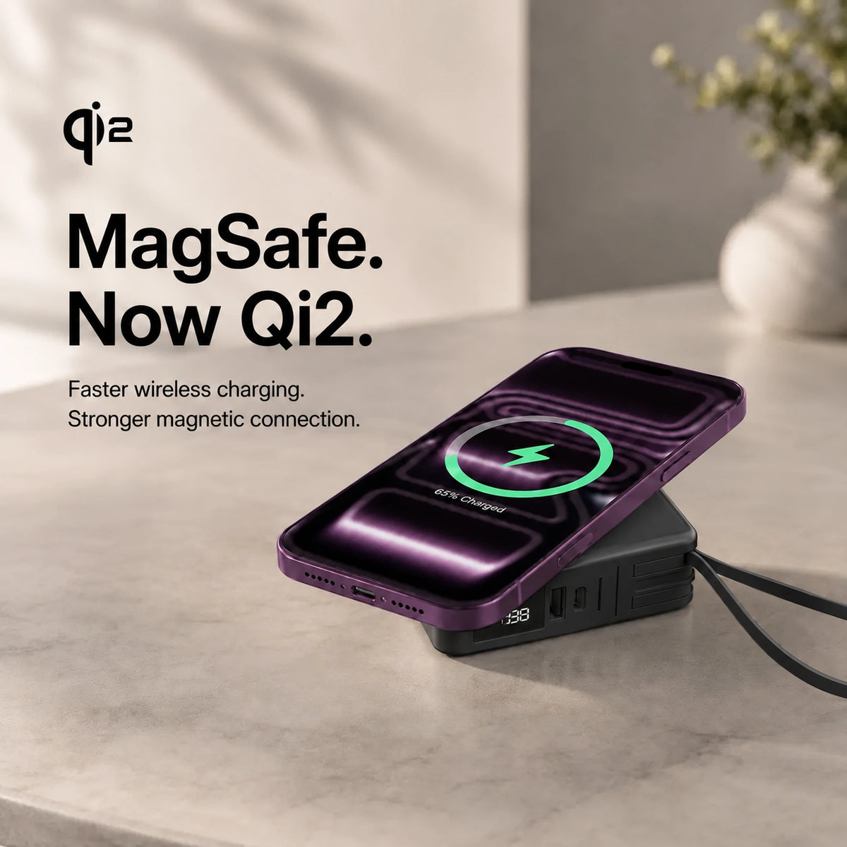 Midnight Black travel power bank charging a phone magnetically #color_Midnight Black