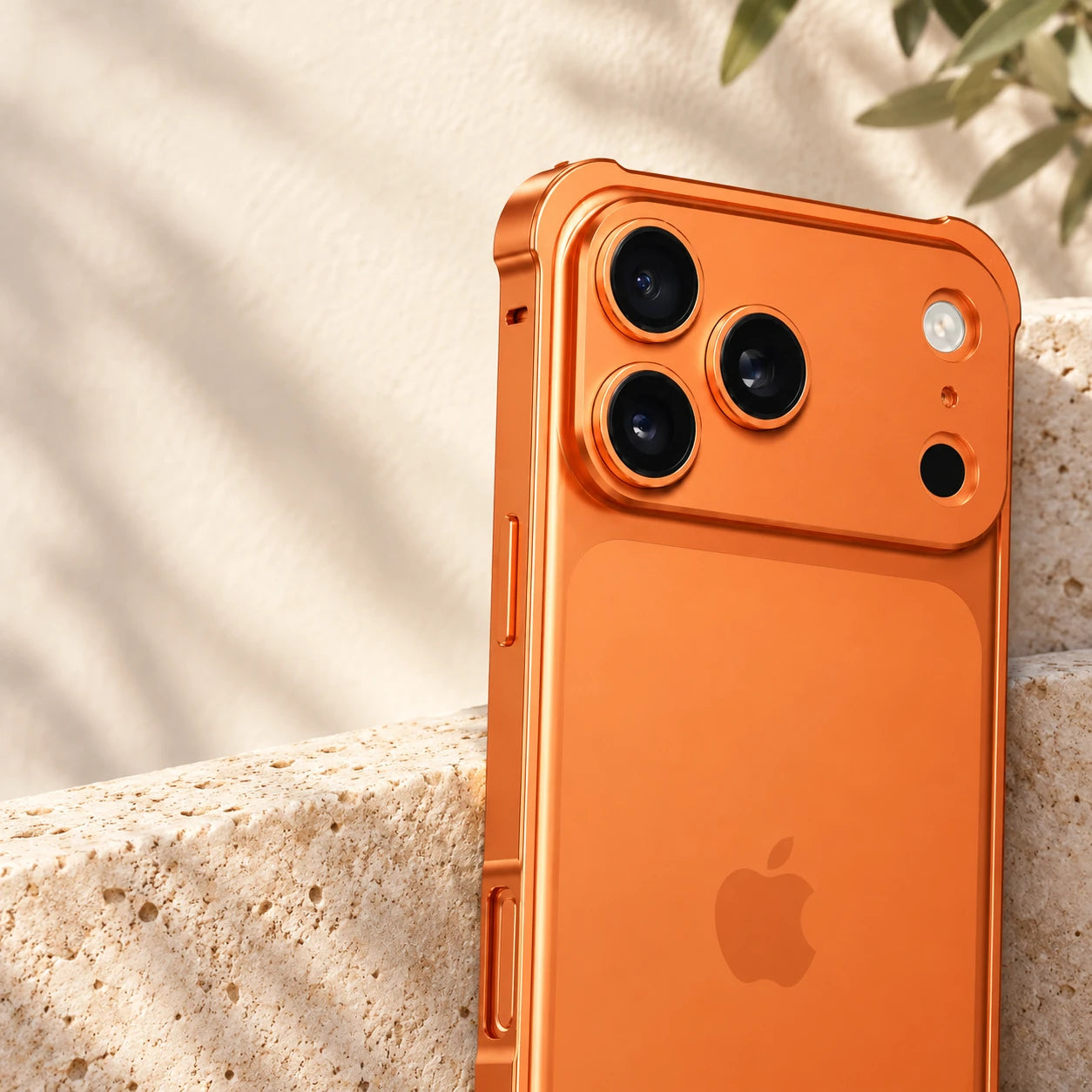 Orange metal camera guard surrounding three rear phone lenses.