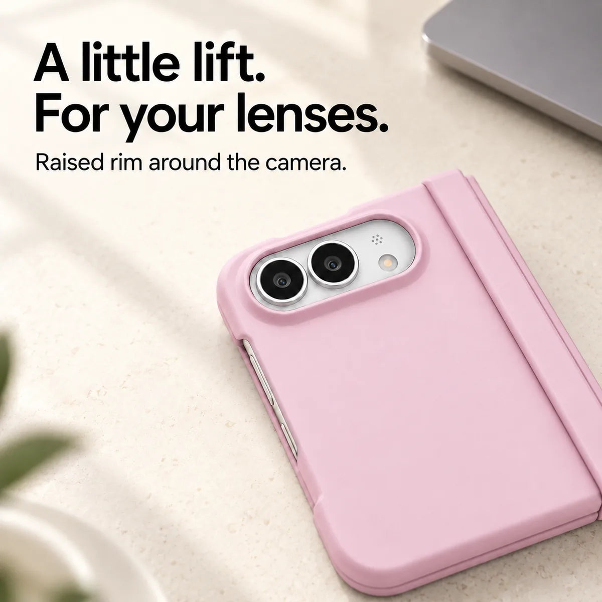 Close-up of the raised Pink camera rim on a matte iPhone Ultra case resting on a light desk. #color_Petal Pink