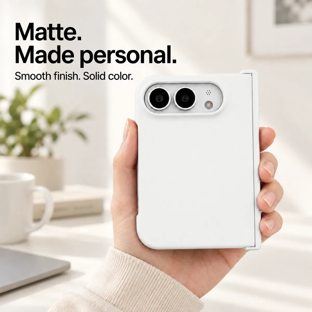 White matte iPhone Ultra case held in one hand, with a smooth solid-color rear shell and silver camera area. #color_Porcelain White